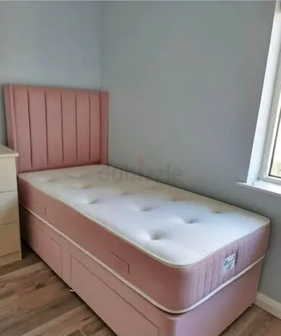 Single pink divan bed with storage and headboard
