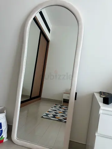 Full-length arched standing mirror with white frame