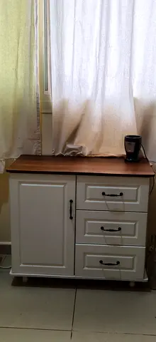 White wooden side cabinet with drawers and walnut top
