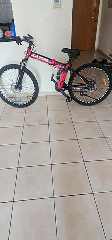 Pink full-suspension mountain bike, used - good condition