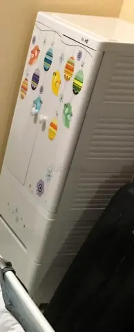 White baby dresser/storage cabinet with playful stickers - good condition