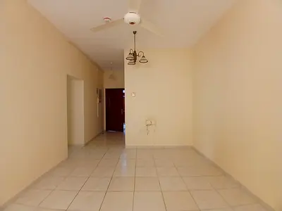 Spacious 2bhk apartment available in window ac central gas family building with balcony in al guwair