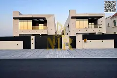 Two-story villa with a rooftop terrace, freehold, in one of Ajman's most prestigious areas, on a mai