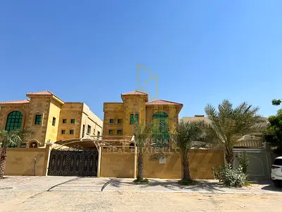 A luxurious commercial and residential villa in a prime location in Al Rawda 2, close to essential services and major roads.