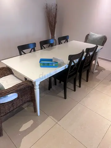 White dining table with 6 black chairs - good condition