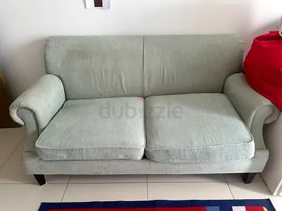 Light green 2-seater fabric sofa in good condition