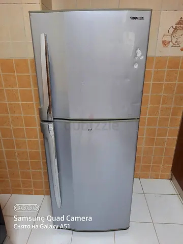 Used double-door silver refrigerator - good working condition
