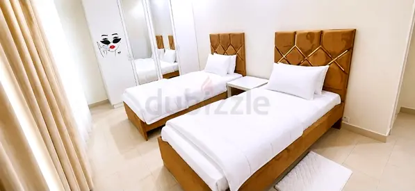 Pair of single beds with upholstered headboards — good condition
