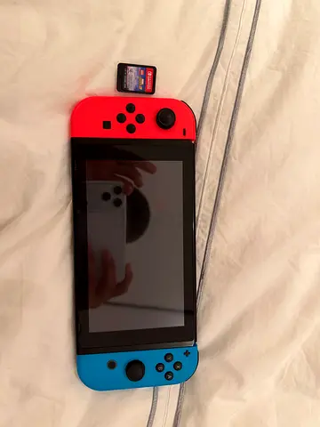 Nintendo Switch console with Joy-Cons + Mario Kart 8 cartridge