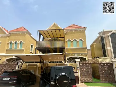 Two-story villa with a rooftop, freehold, in one of Ajman's most prestigious areas, on a main street, price includes electricity, water, and air condi