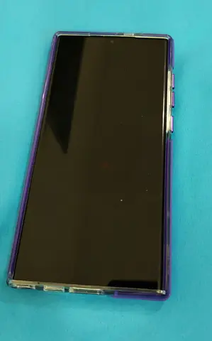 Samsung Galaxy S23 ultra with MagSafe-style ring (purple trim) charging case