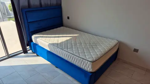 Original: AED 3,250, Single blue upholstered bed frame with mattress