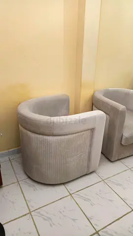 Pair of beige curved swivel armchairs - good condition