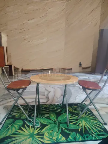 Small folding bistro table with two matching folding chairs - good condition