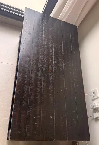 Dark wooden coffee table — solid top, needs minor touch-ups