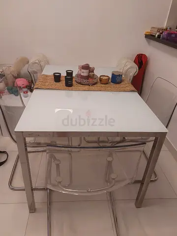 Compact white glass dining table with chrome frame with 5 chairs