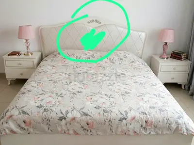 White upholstered double bed with floral mattress with two nightstands - good condition