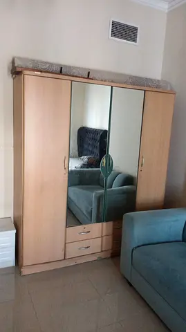 Beige Wooden Wardrobe with Mirrored Doors and Drawers