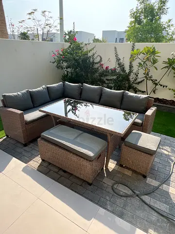 Outdoor rattan corner sofa set with glass-top table and cushions