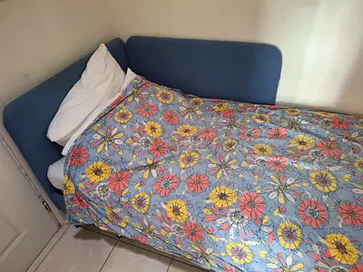 Single blue upholstered bed/sofa with headboard and mattress - nanny room size - good condition