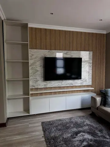 Modern built-in TV entertainment unit with shelving and storage