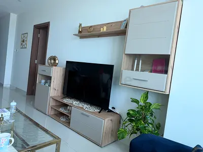 Modern light-wood TV entertainment unit with wall cabinet and shelf