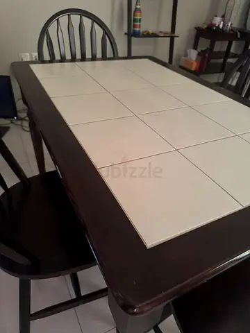 Wooden dining table with tiled top and matching chairs - good condition