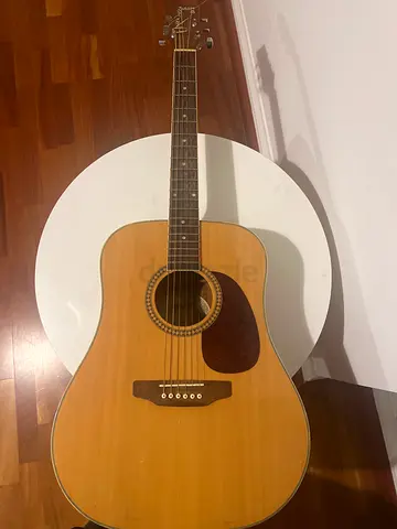 Used acoustic guitar in average condition - ready to play