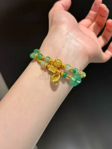 Pair of green jade bead bracelets with gold charms