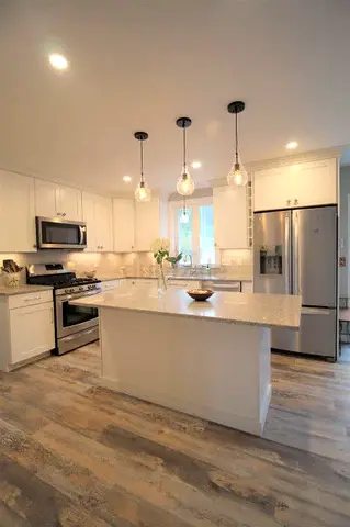 Modern white kitchen with storage and marble top with hanging
