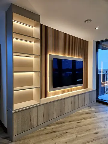Modern built-in entertainment unit with LED shelving and TV mount