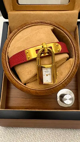 Vintage Hermès Kelly-style padlock watch on red leather bracelet