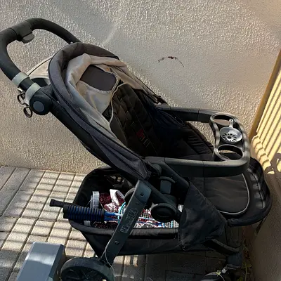 Used black/grey stroller with snack tray and storage basket