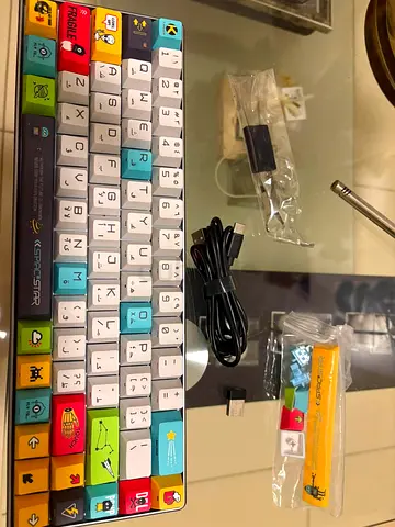 Compact colorful mechanical keyboard with extra keycaps and USB-C cable