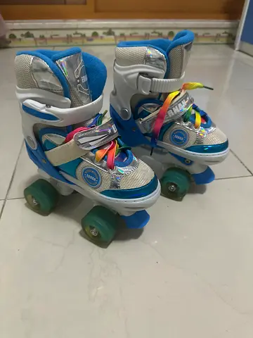 Kids adjustable 4-wheel roller skates, size small, with rainbow laces