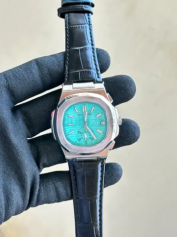 Mens stainless steel automatic watch with teal dial and leather strap
