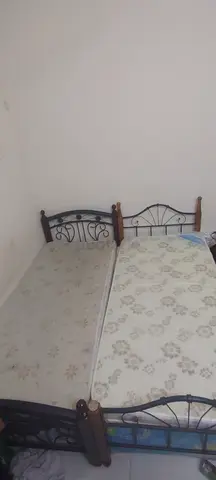 Two single metal frame beds with mattresses - good condition