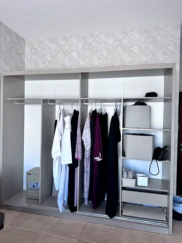 Open wardrobe/closet organizer with hanging rails and storage shelves