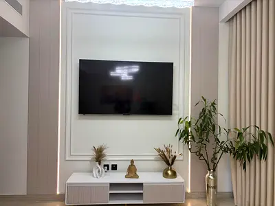 Modern low TV cabinet / media console in white with ribbed doors