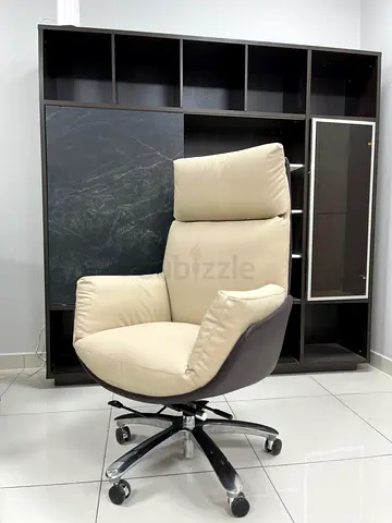 Comfortable beige leather swivel office chair with high back