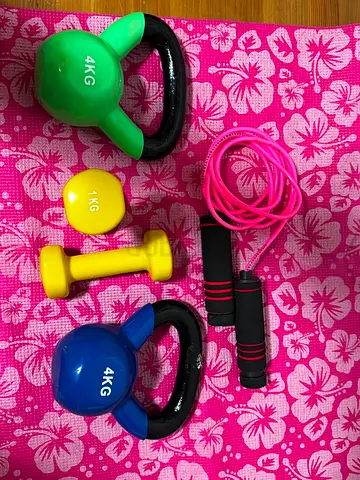 Set of kettlebells, dumbbell and jump rope - light weights (4kg, 1kg) on mat