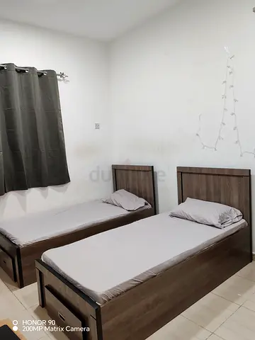 Two single wooden beds with mattresses - good condition