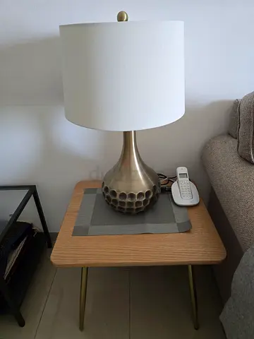 Brass Table Lamp with White Shade on Wooden Side Table