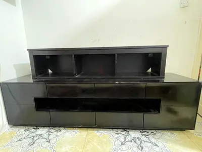 Black wooden TV entertainment unit with storage shelves