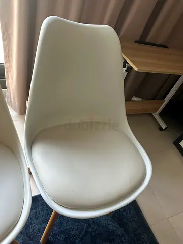 Set of 2 modern white molded plastic dining chairs with wooden legs