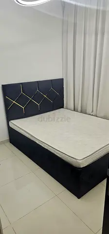 King-size upholstered bed frame with mattress — good condition