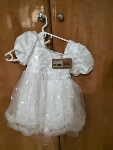 White baby girl party dress with puff sleeves
