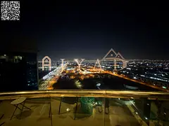 2BR apartment for sale in Conquer Tower, Ajman. Freehold, 2100 sqft, 2 balconies, open view, prime l