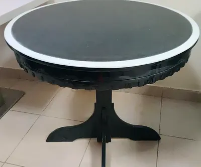 Round wooden dining table with pedestal base - black