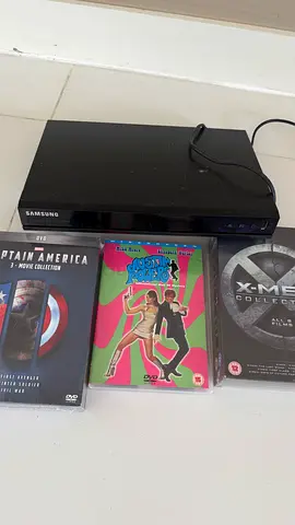 Samsung DVD player with mixed DVD movie collection (X-Men, Austin Powers, Captain America set)
